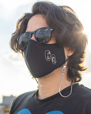 Man using face mask chain holder with his mask around the neck