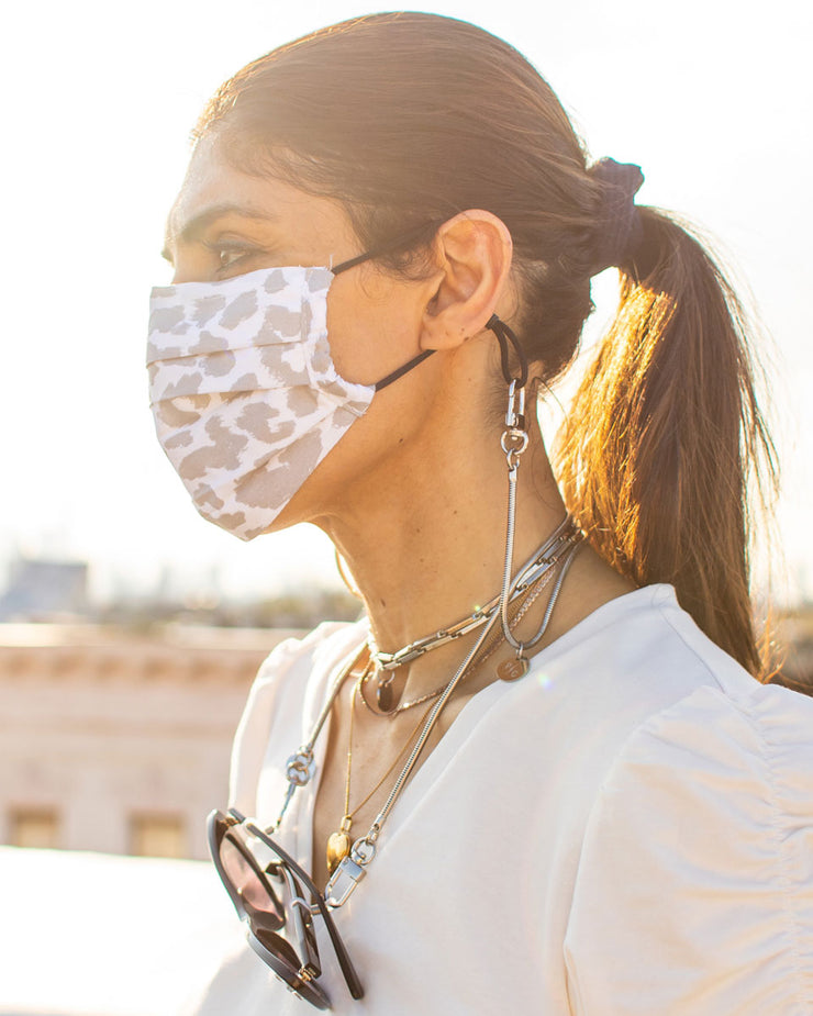 Girl using Charlie snake chain as a mask holder around the neck and with sunglasses