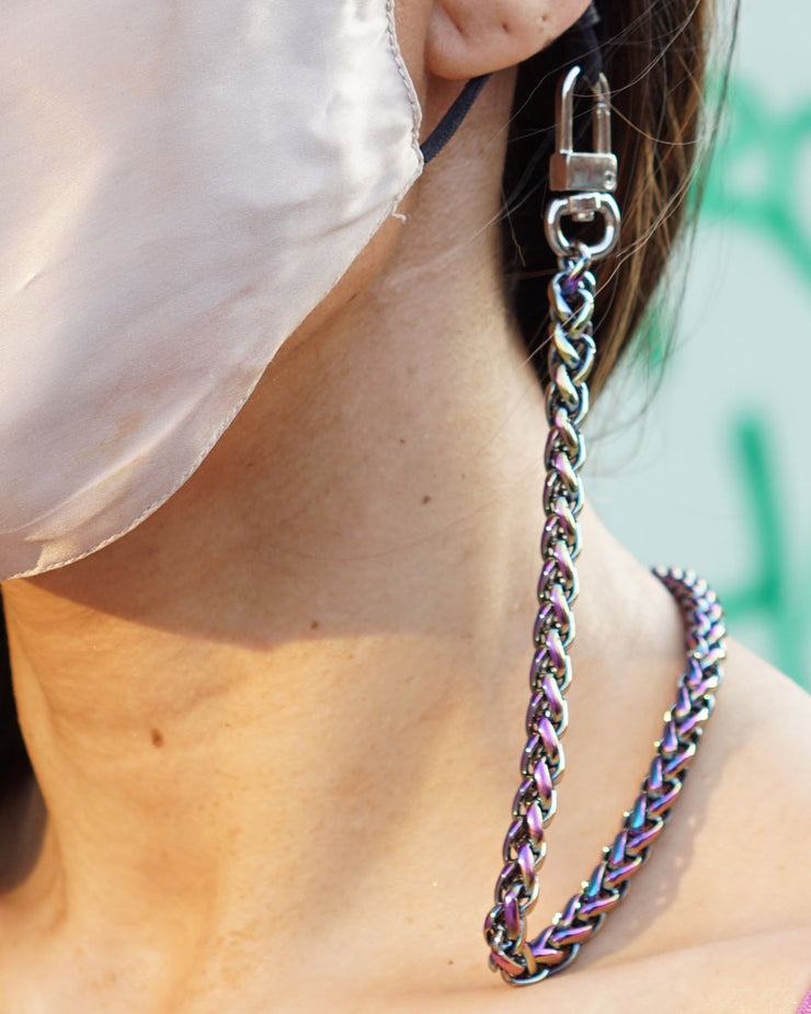 Close up photo of rainbow face mask chain holder worn around neck and ear