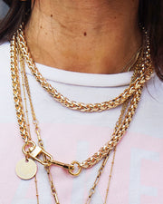 The Nikki gold long chain being worn as a stylish, modern necklace