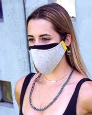 Stylish iridescent rainbow long face mask necklace chain being worn with face mask by girl 